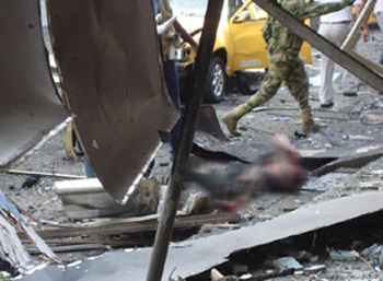 Man lying unconscious, under rubble after car bomb explodes ripping through shops - image by: El País News Agency 