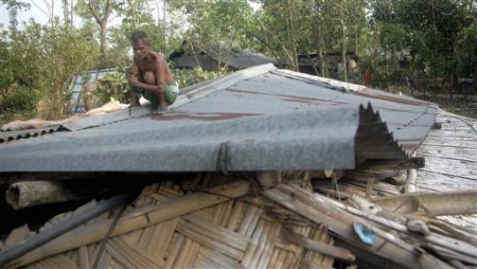 An Indian villager trying to repair his home after it was demolished in the storm that devastated the region of the countryAP Photo/Tamal Roy