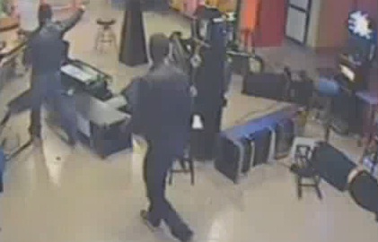 Images of CCTV footage where masked and armed men thought to be members of an Italian god father wreck havoc in a bowling and arcade. 