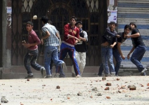 Protesters hurling stones, an act which has become popular in riots protests against the government. 