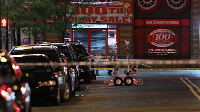 A NYPD bomb squad robot examines the vehicle which posed the threat in the 