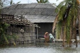 A mother and grandmother trying to comfort their child after heavy downfall caused landslides in South East Bangladesh. - Photo by : AFP