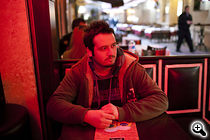 Serdar, 25, studied business at Istanbul University and now works as a waiter in central Istanbul. He wants to finish university, but does not believe he'll be able to get a better job. (Photo: Justin Vela)