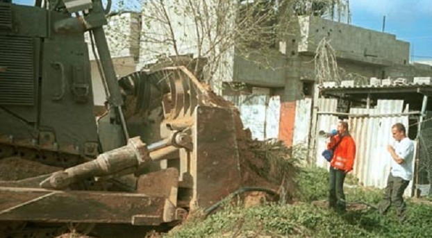 Rachel Corrie in front of an Israeli army bulldozer at Rafah, 16 March 2003