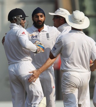 English spinner Monty Panesar being congratulated by teammates after taking an Indian wicket. He bagged 11-wickets in the test. 