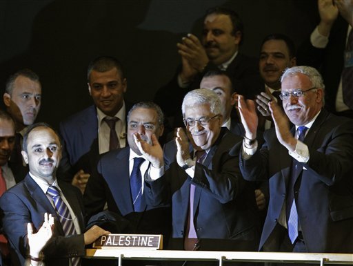 Members of the Palestinian delegation and others join Palestinian President Mahmoud Abbas by applauding during a meeting of the United Nations General Assembly after a vote on a resolution on the issue of upgrading the Palestinian Authority's status to non-member observer state passed in the United Nations. The United Nations voted overwhelmingly Thursday to recognize a Palestinian state, a long-sought victory for the Palestinians but an embarrassing diplomatic defeat for the US