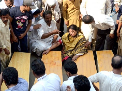 Women stand near the coffin of their near ones killed in suicide bombing in Peshawar, Pakistan.